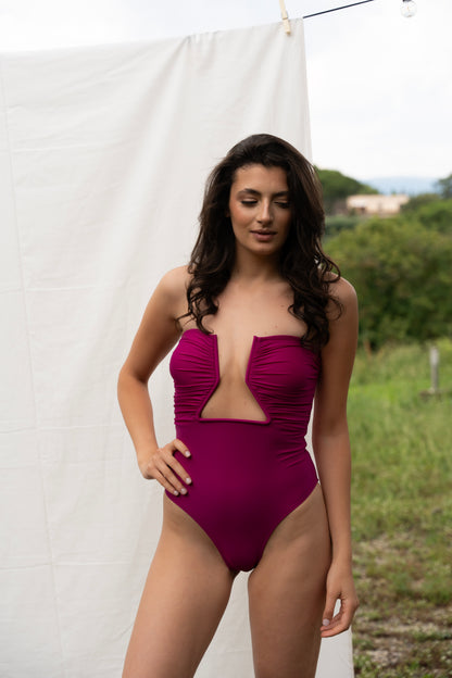 A woman in a Nayades the Label Coco de Mer One-Piece Fuchsia swimsuit.