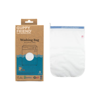 A pack of Nayades the Label Guppyfriend™ washing bags next to a cardboard box.